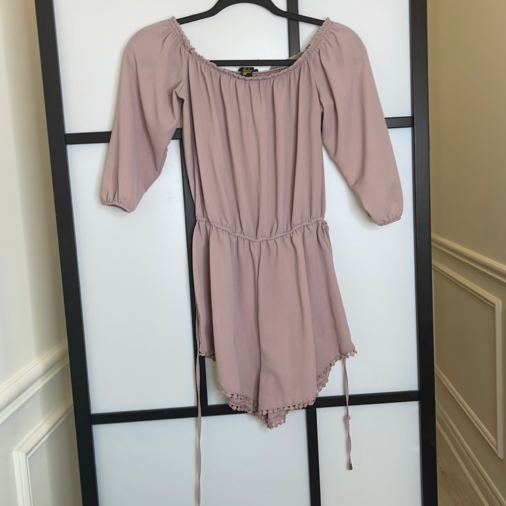 Pink romper with tightness adjuster around waist